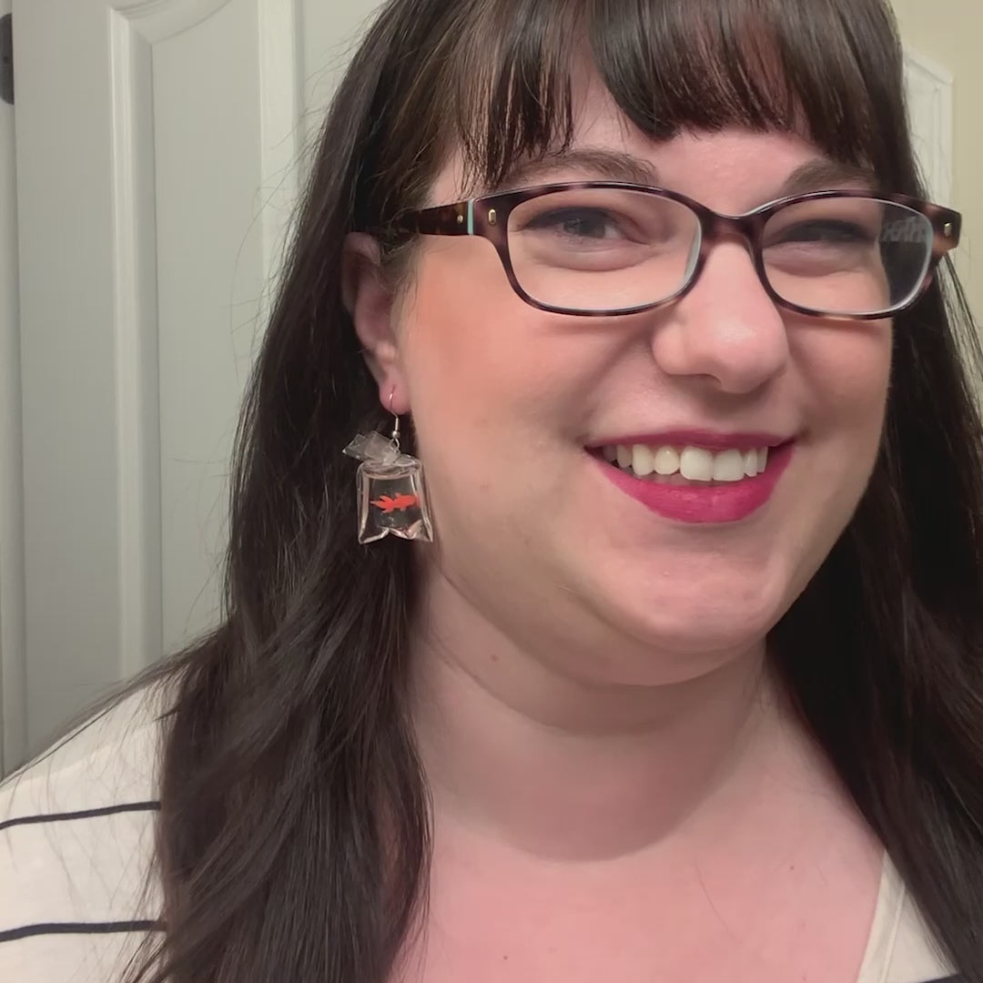 video women wearing fish earrings