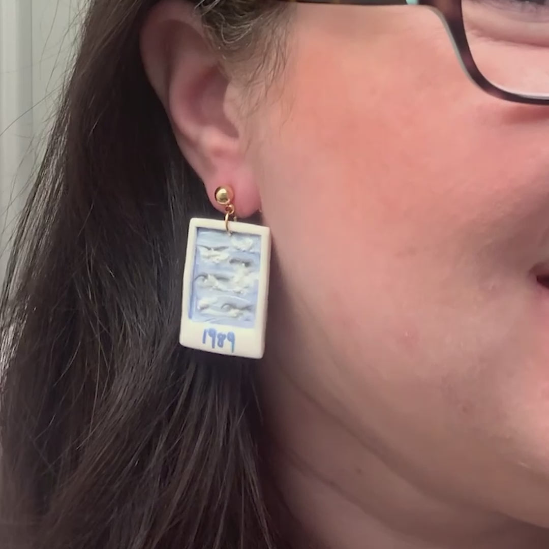 woman wearing taylor swift earrings 1989 swifties earrings swifties