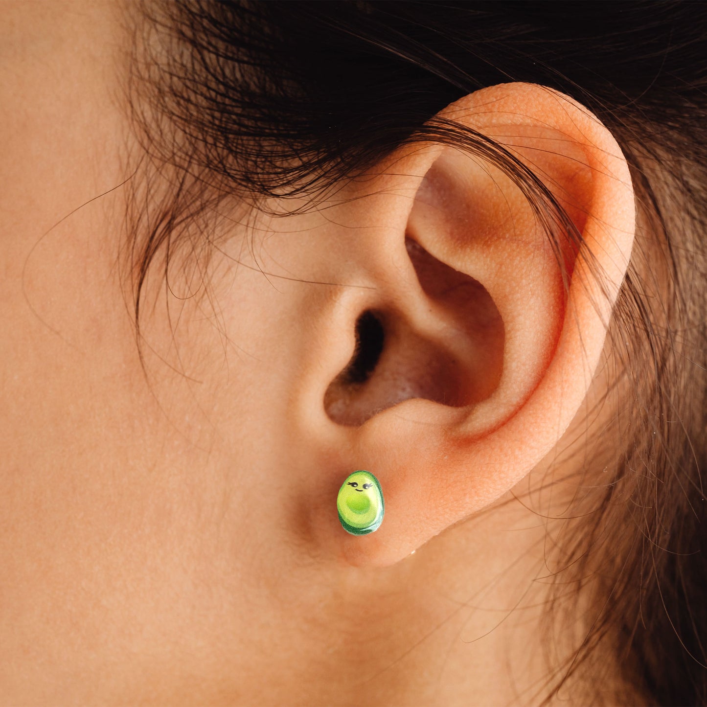 woman wearing cute avocado earrings