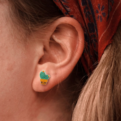 woman wearing cute cactus earrings with yellow flower