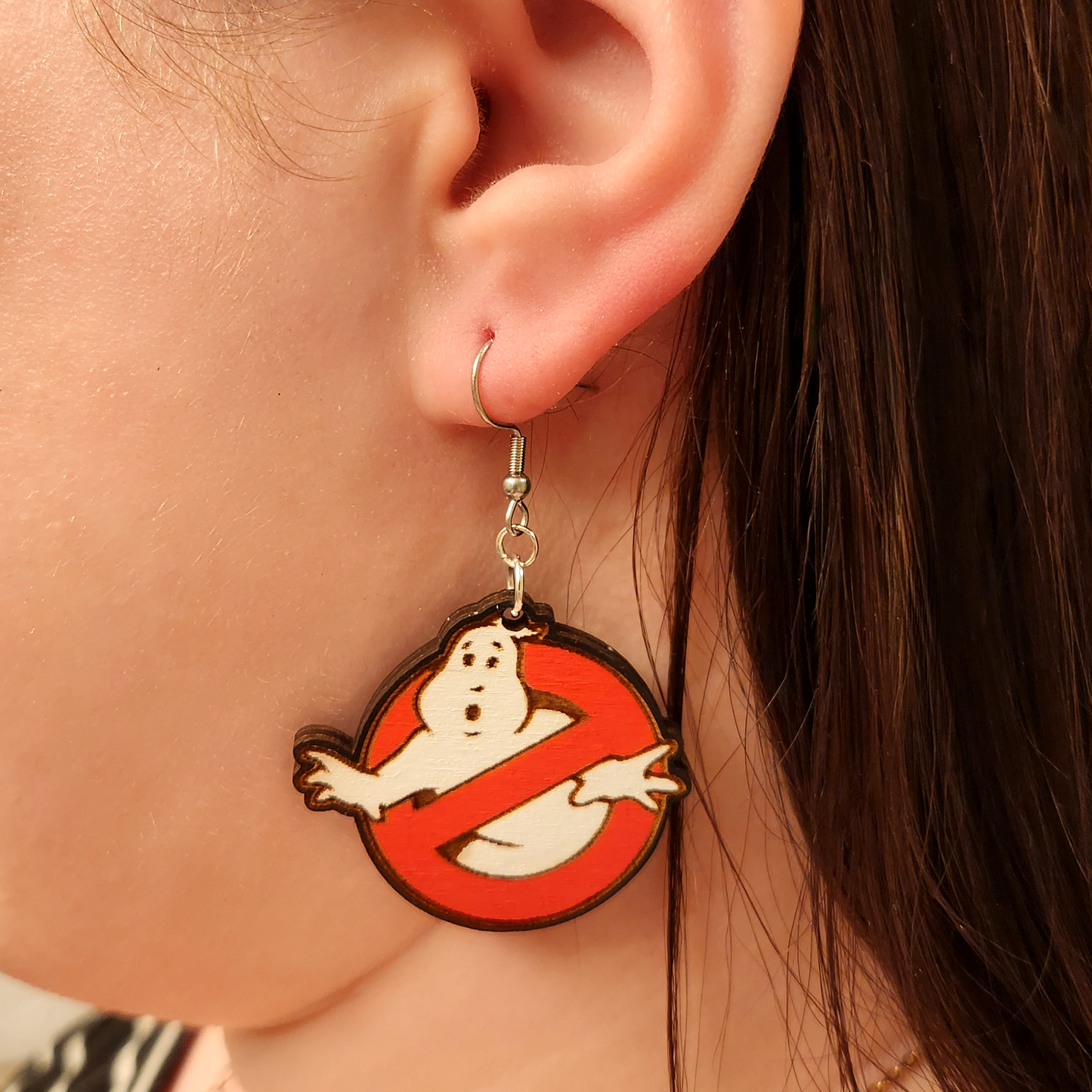 woman wearing ghostbusters earrings