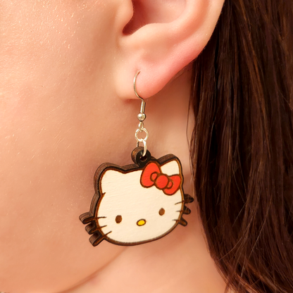 woman wearing hello kitty inspired earrings