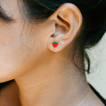 woman wearing strawberry earrings