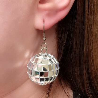 woman wearing disco ball earrings