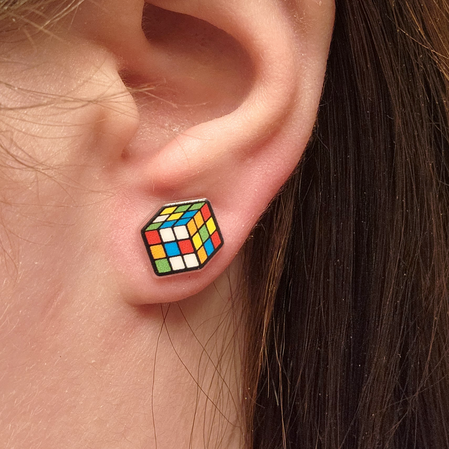 woman wearing rubix cube earrings