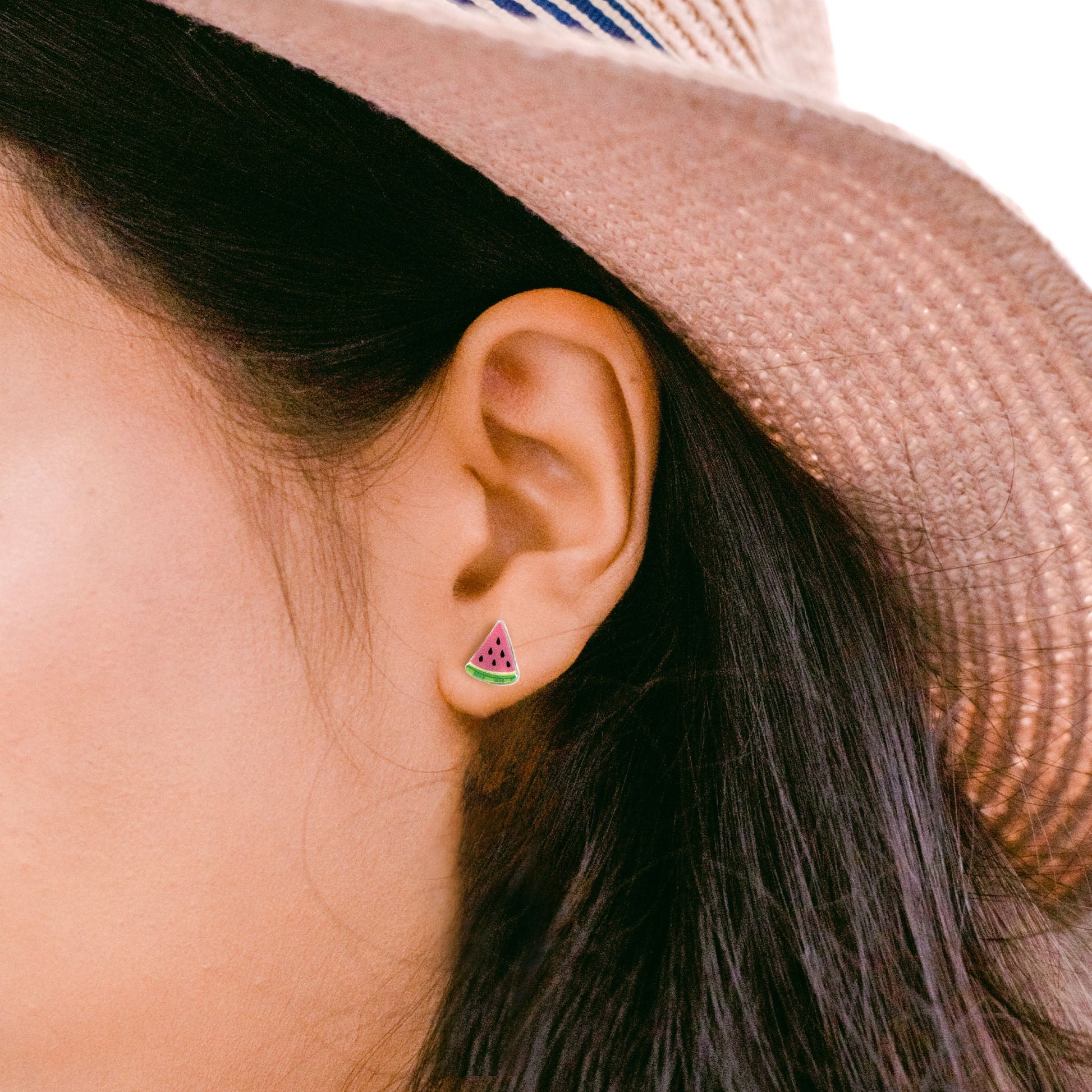 woman wearing watermelon fruit earrings